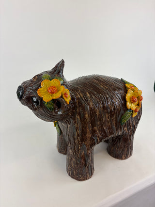 Sculpture-wombat yellow flowers