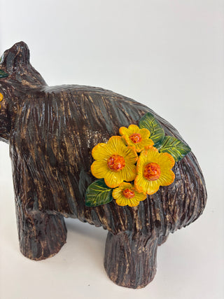 Sculpture-wombat yellow flowers