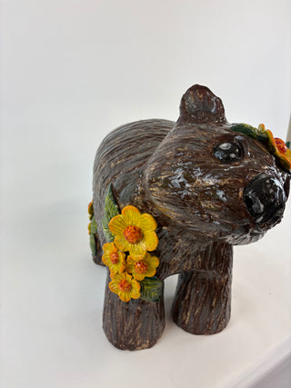 Sculpture-wombat yellow flowers