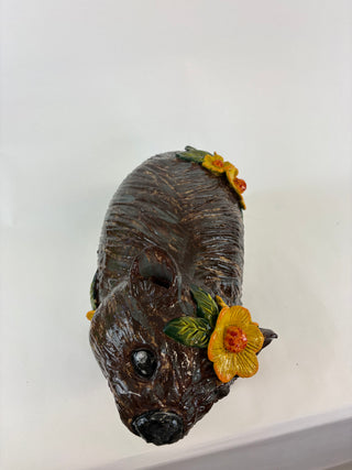 Sculpture-wombat yellow flowers
